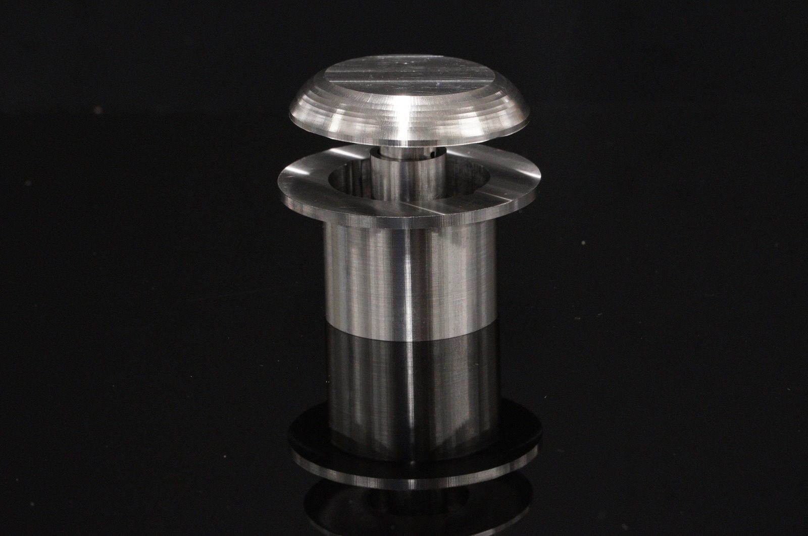Final machined stainless TubStep prototype on a black background