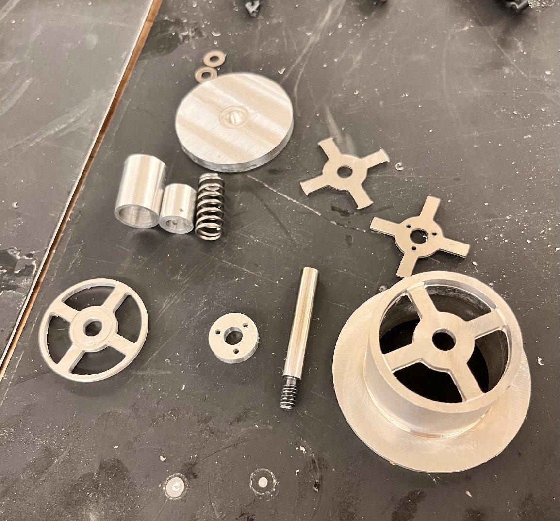 Machined parts laid out on a bench